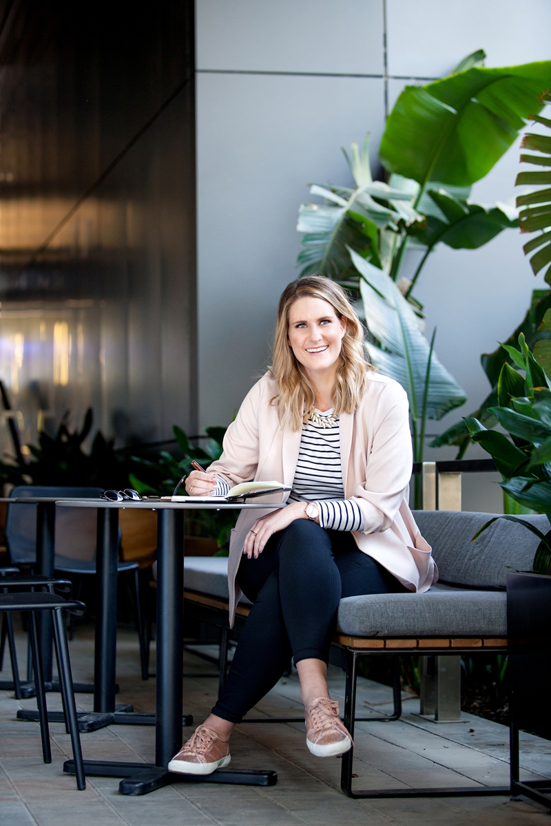 Business woman writing in a journal in tropical setting