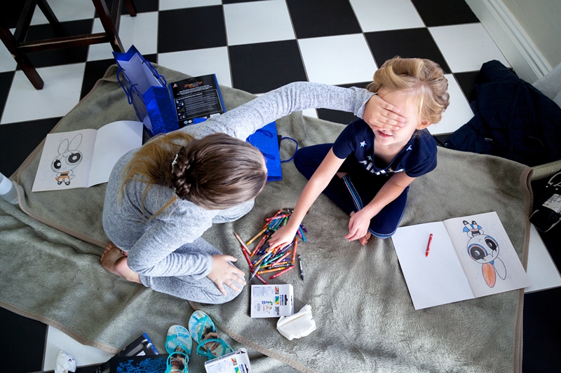 Kids with crayons, and hand covering their eyes at the Estuary Hotel, Port Edward.