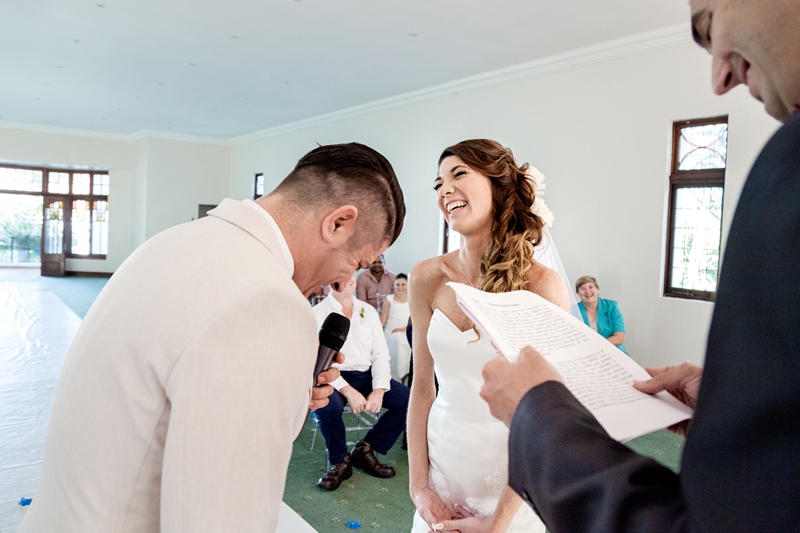 Bride and groom laughing during ceremony at Estuary Hotel, Port Edward.
