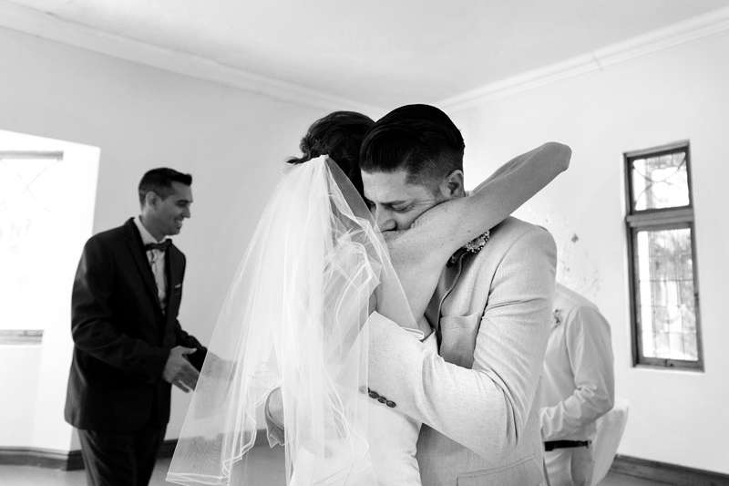 Bride and groom hugging after ceremony at Estuary Hotel, Port Edward.