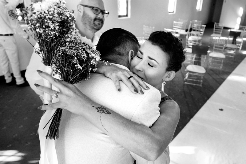 Guest hugging groom at wedding at Estuary Hotel, Port Edward.