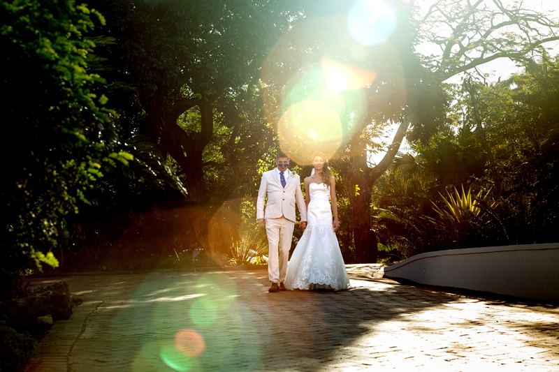 Bride and groom walking in afternoon light, at the Estuary Hotel, Port Edward.