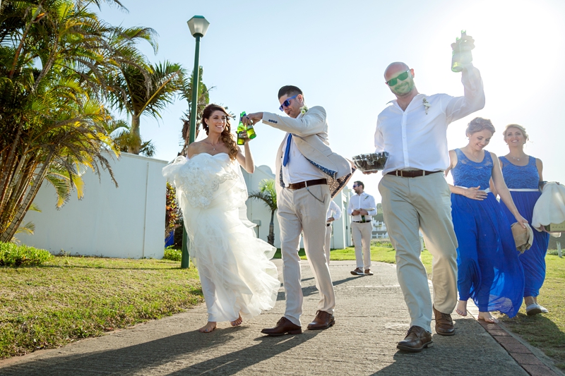 Bridal and groom toasting while walking, at the Estuary Hotel, Port Edward.