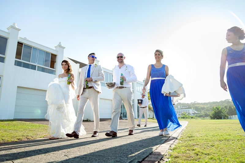 Bridal party walking with beers in hand, at the Estuary Hotel, Port Edward.