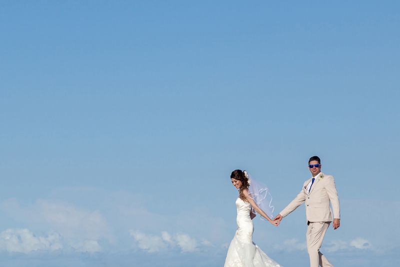 Bridal leading groom with blue sky in the background at the Estuary Hotel, Port Edward.