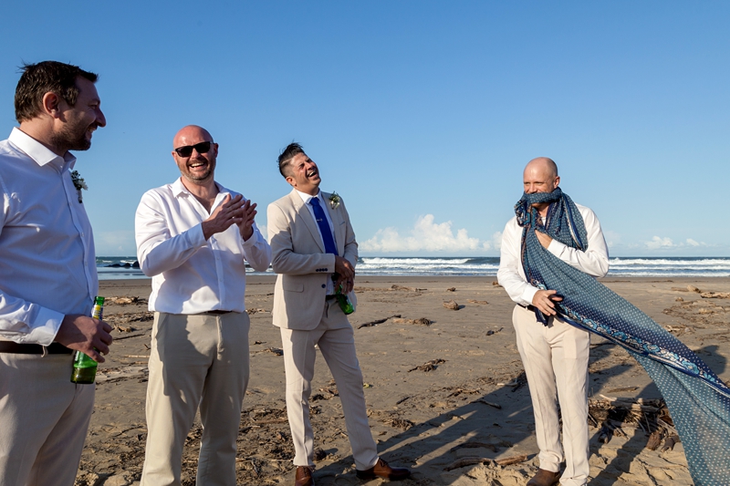 Groomsman laughing on the beach at the Estuary Hotel, Port Edward.