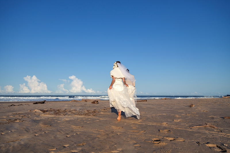 Bride following groom onto the beach during afternoon light at the Estuary Hotel, Port Edward.