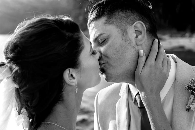 Bride and groom kissing during afternoon light at the Estuary Hotel, Port Edward.