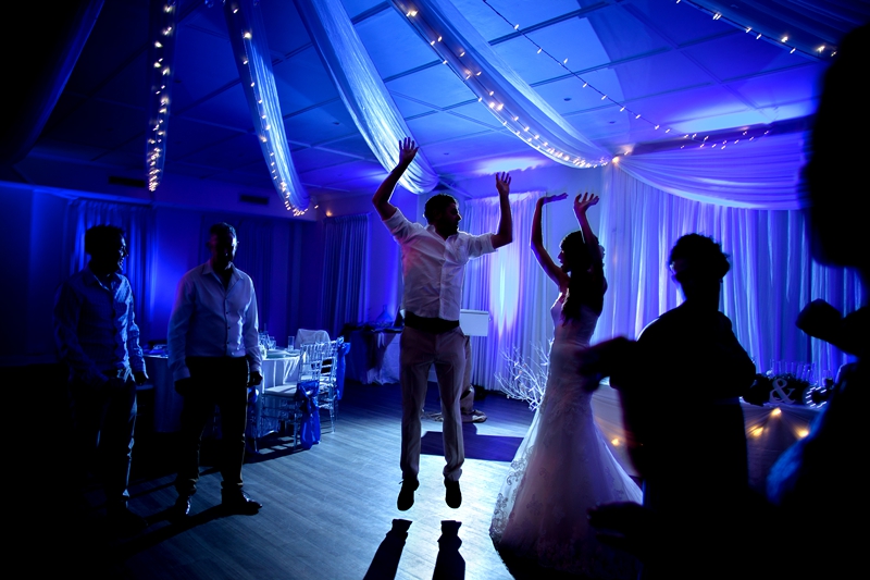Bride and groom with their hands in the air at Estuary Hotel