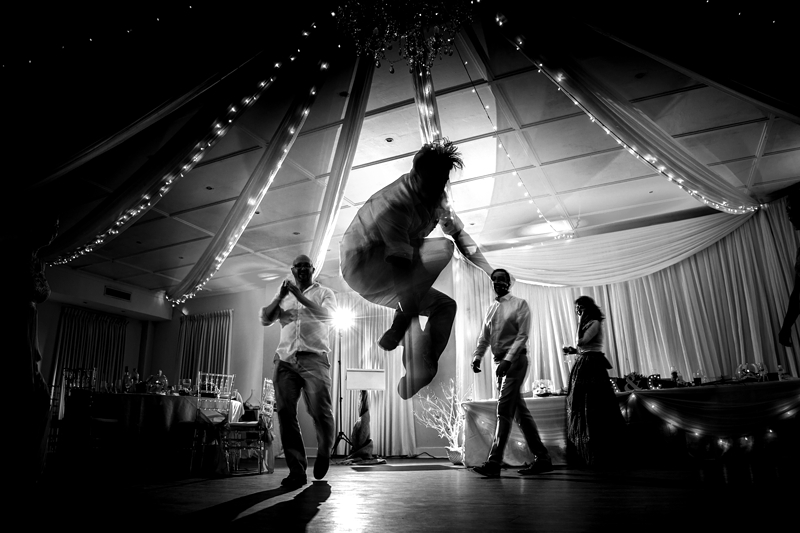 Groom jumping through the air at Estuary Hotel