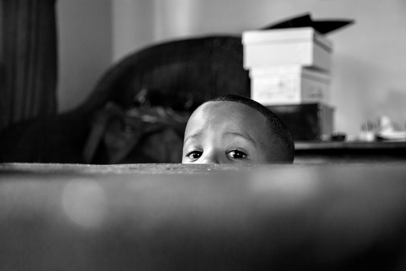 Black and white photograph, peeking child at Valverde Eco Hotel.