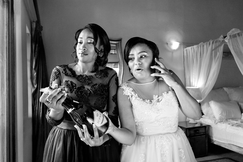 Black and white photograph, popping champagne at Valverde Eco Hotel.
