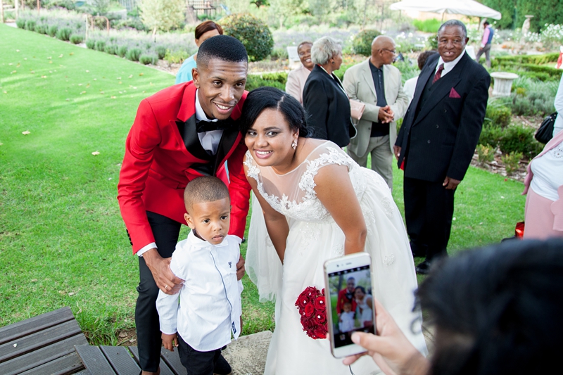 Bride and groom taking a photograph with child at Valverde Eco Hotel.