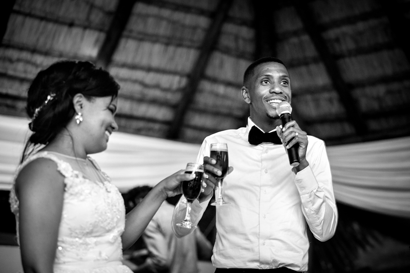 Black and white photograph, bride and groom toasting at Valverde Eco Hotel.