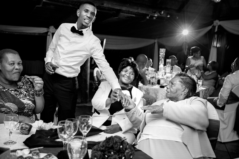 Black and white photograph, groom with guests at Valverde Eco Hotel.