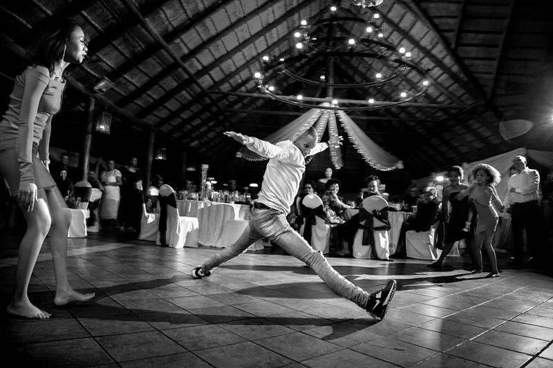 Black and white photograph, guest doing the splits at Valverde Eco Hotel.