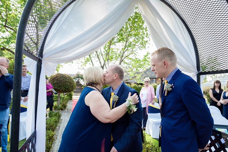 Groom kissing mom on the cheek at Valverde Eco Hotel.
