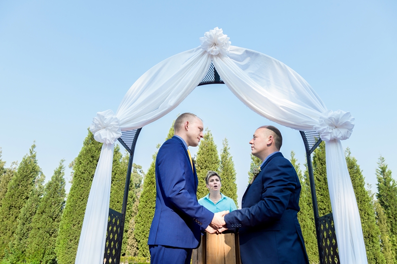Grooms looking at each other during ceremony at Valverde Eco Hotel.