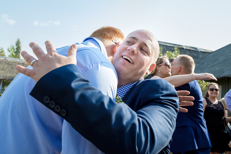 Groom hugging guest at Valverde Eco Hotel.