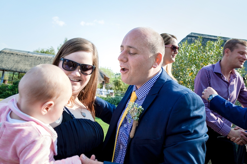 Groom playing with baby at Valverde Eco Hotel.