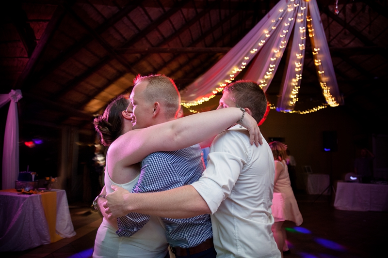 Guests give groom sandwich hug at Valverde Eco Hotel.