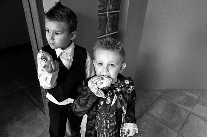 Kids at Alice in Wonderland themed wedding, eating doughnuts.