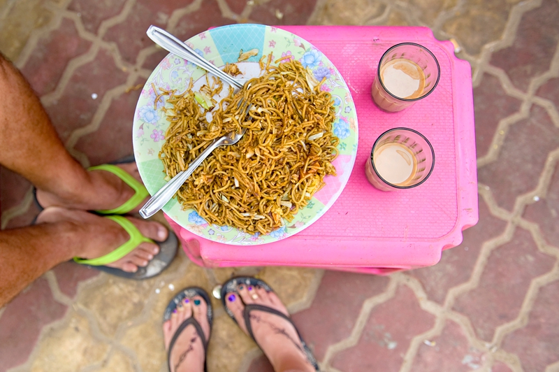 Egg fried rice and chai tea on a pink table in Goa, India