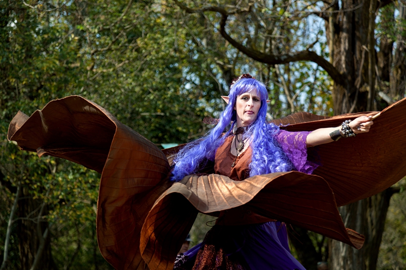 Forest fairy with purple hair, dancing during Hippie Fest, at the Forest Venue.