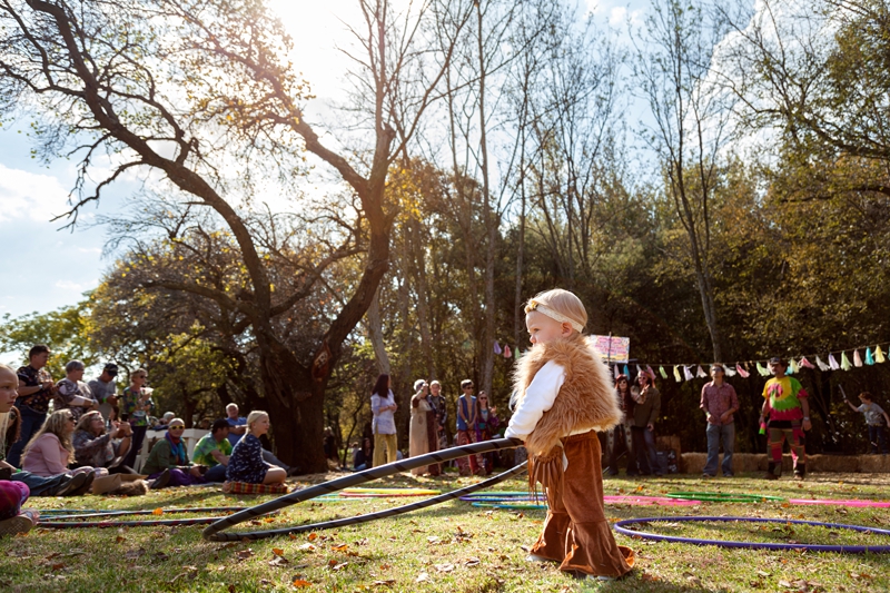 Hippie baby playing with hula hoop dressed by JUST ME by Willow Lee during Hippie Fest, at the Forest Venue.