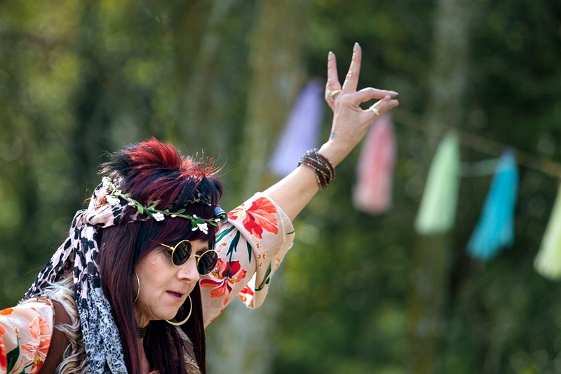 Lady hippie, with red hair smoking a joint, during Hippie Fest, at the Forest Venue.
