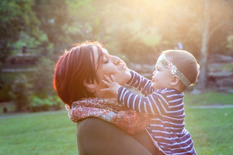Girl toddler playing with moms face at Japanese Gardens, Pinetown.