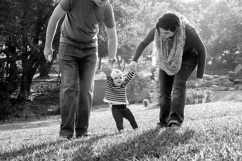 Girl toddler pulling a funny face while walking with parents, at Japanese Gardens, Pinetown.