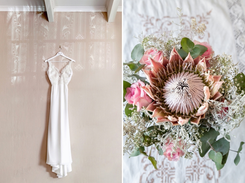 White lace wedding dress and pink Protea bouquet.