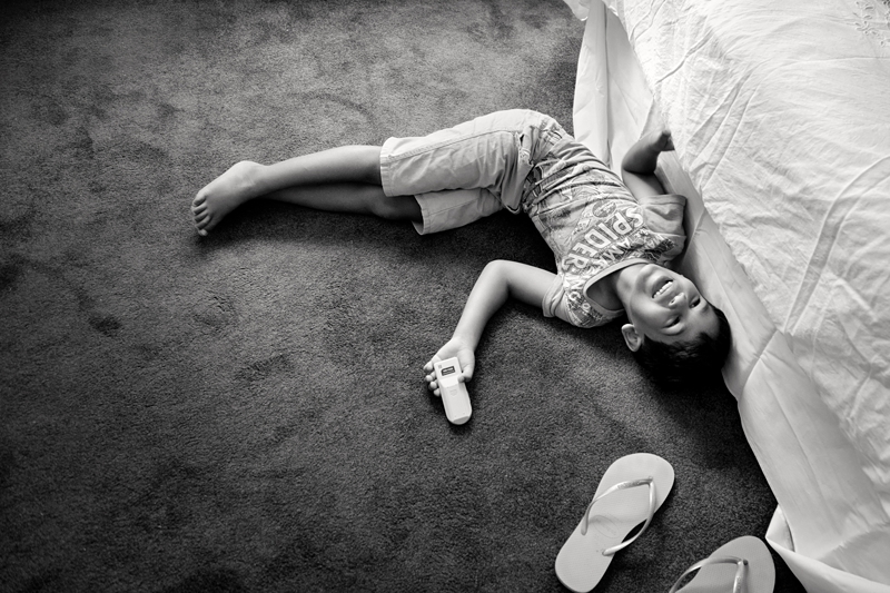 Child laughing on the floor.