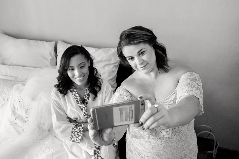 Bride and bridesmaid taking a selfie.