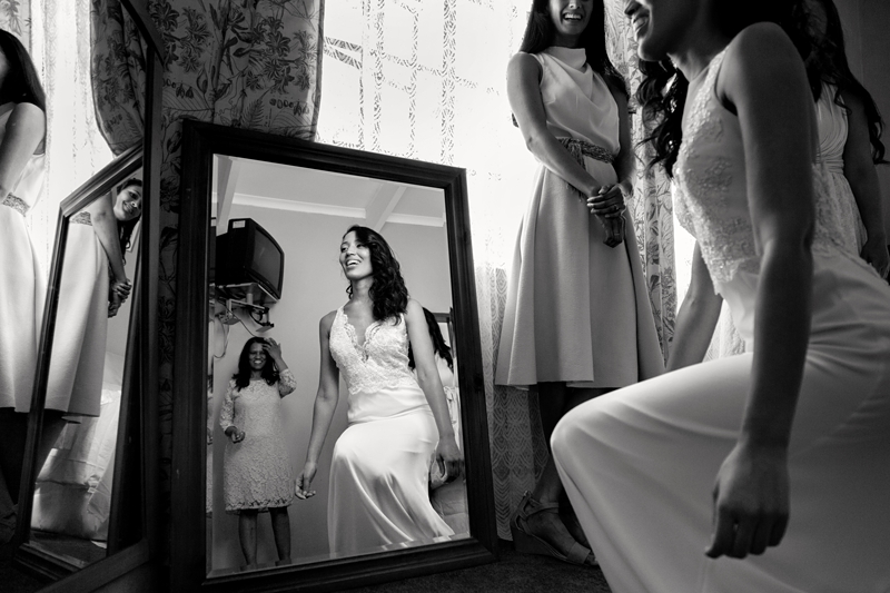 Bride looking at her reflection in the mirror.