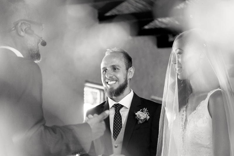 Groom laughing during wedding ceremony at Leafy Green Cafe.