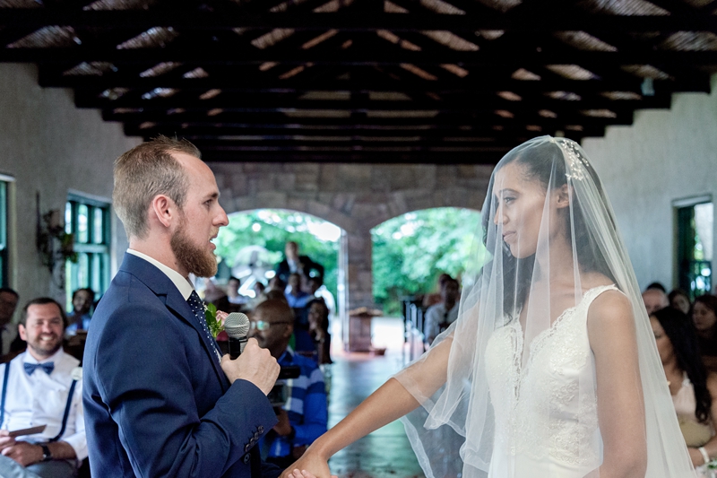 Groom saying vows to his bride during ceremony at Leafy Green Cafe.