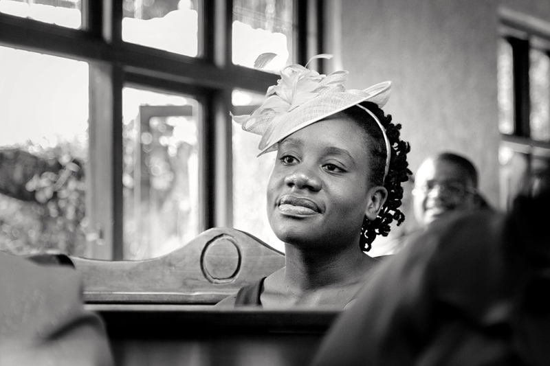 Guest wearing fascinator during wedding ceremony at Leafy Green Cafe.