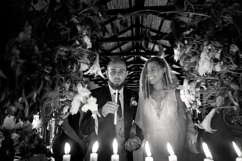 Bride and Groom lighting candles during wedding ceremony at Leafy green Cafe