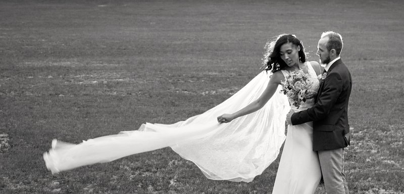 Brides long veil blowing in the wind at Leafy Green Cafe.
