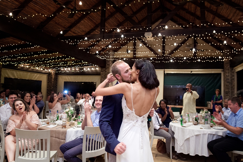 Bride and groom kissing during reception at Leafy Green Cafe.