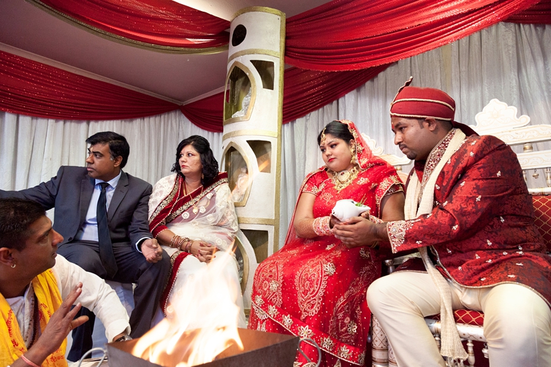 Bride and groom during Hindu ceremony at Shree Radhe Shyam Mandir.