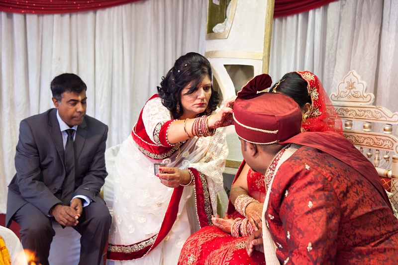 Bride and groom during Hindu ceremony at Shree Radhe Shyam Mandir.