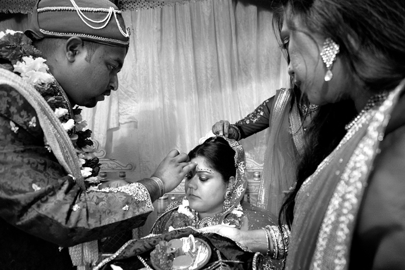 Bride and groom during Hindu ceremony at Shree Radhe Shyam Mandir.