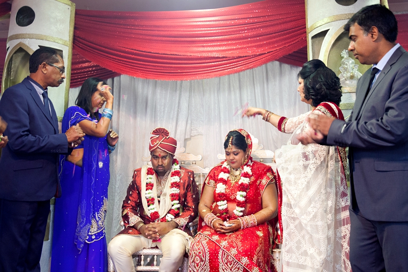 Bride and groom during Hindu ceremony at Shree Radhe Shyam Mandir.