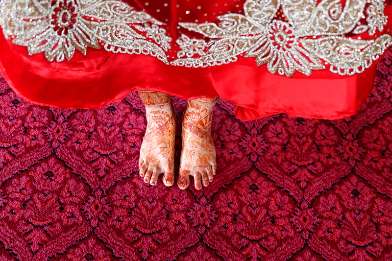 Bridal mhendi on brides feet, on red carpet at each other at Shree Radhe Shyam Mandir.