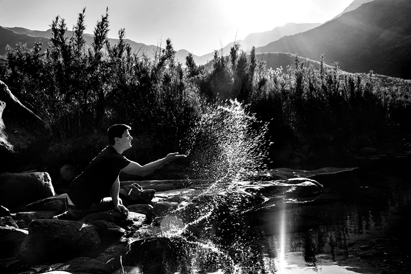 Guy playing in the river of the Maluti Mountains in Lesotho.