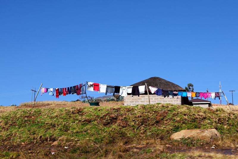 Clothes on washing line in front of Lesotho hut. 